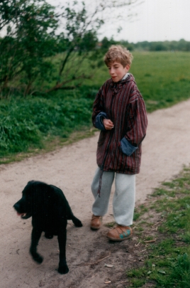 Beim Spaziergang Kind mit schwarzem Labrador gehen spazieren.